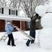 Brandon Rink, 6, watches as his mother Susan holds a ladder and his father David pushes the head of their giant snowman into place on Wednesday, Feb. 27, 2013 on Glen Leven Rd. The family, along with siblings Justin, 8 and Chloe, 3, started building the snowman the night before creating the base out snow from the driveway. Melanie Maxwell I AnnArbor.com